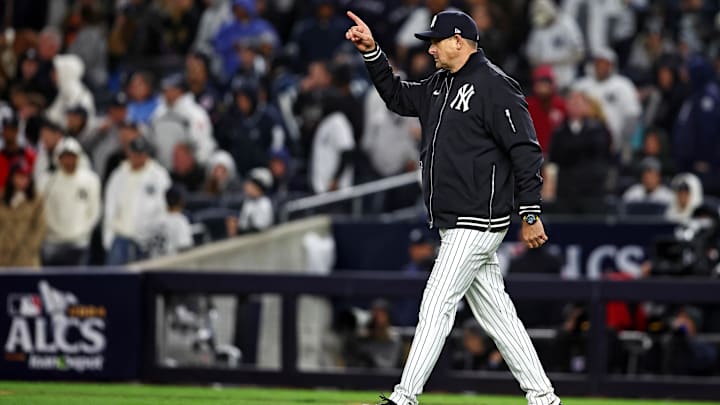 Oct 14, 2024; Bronx, New York, USA; New York Yankees manger Aaron Boone signals to the bull pen for a pitching change eighth inning against the Cleveland Guardiansin game one of the ALCS for the 2024 MLB Playoffs at Yankee Stadium. Mandatory Credit: Wendell Cruz-Imagn Images