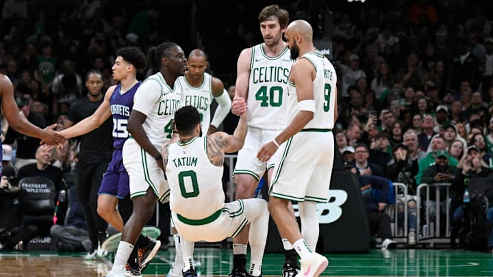 Apr 11, 2025; Boston, Massachusetts, USA; Boston Celtics guard Jrue Holiday (4) and .center Luke Kornet (40) help forward Jayson Tatum (0) to his feet during the second half against the Charlotte Hornets at TD Garden. Mandatory Credit: Eric Canha-Imagn Images