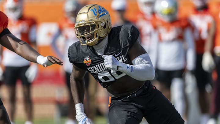 Jan 29, 2025; Mobile, AL, USA; National team defensive lineman Oluwafemi Oladejo of UCLA (99) runs through a drill during Senior Bowl practice at Hancock Whitney Stadium. Mandatory Credit: Vasha Hunt-Imagn Images