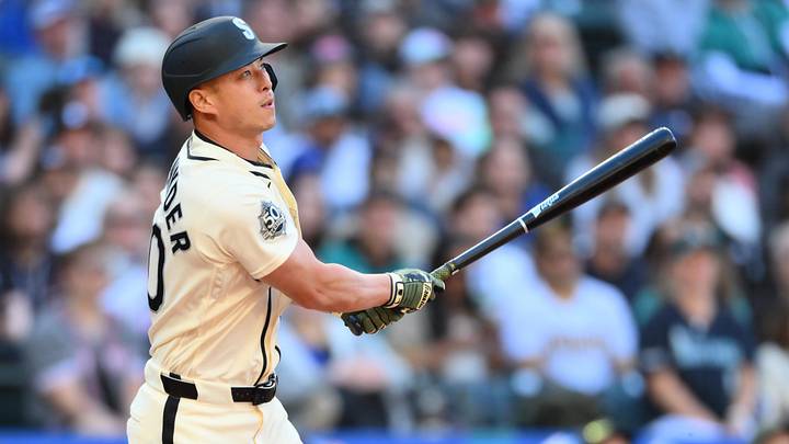 May 17, 2026; Seattle, Washington, USA; Seattle Mariners pinch hitter Rob Refsnyder (30) hits a sacrafice fly ball against the San Diego Padres during the sixth inning at T-Mobile Park. Mandatory Credit: Steven Bisig-Imagn Images