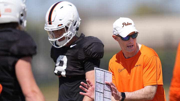 Oklahoma State quarterbacks coach Kevin Johns runs drills with the quarterbacks during a Spring football practice at Oklahoma State University in Stillwater, Okla., Tuesday, April, 8, 2025.