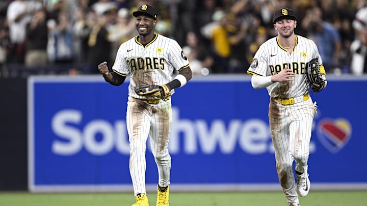 Sep 21, 2024; San Diego, California, USA; San Diego Padres left fielder Jurickson Profar (left) celebrates after a diving catch to end the top of the seventh inning against the Chicago White Sox at Petco Park. Mandatory Credit: Orlando Ramirez-Imagn Images