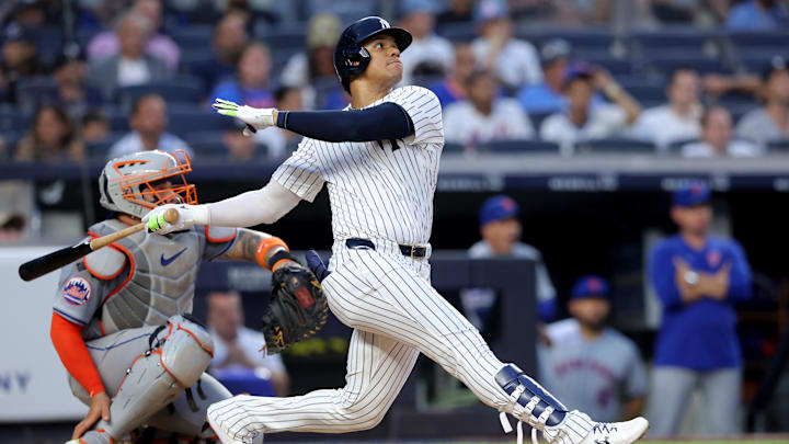 Jul 24, 2024; Bronx, New York, USA; New York Yankees right fielder Juan Soto (22) follows through on a solo home run against the New York Mets during the third inning at Yankee Stadium. Mandatory Credit: Brad Penner-Imagn Images