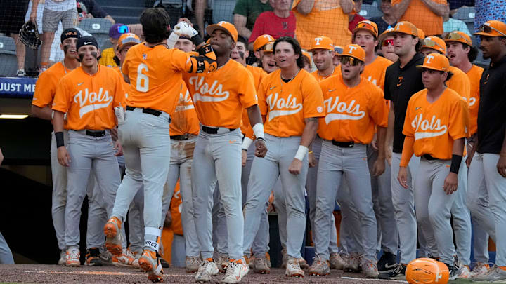 Tennessee shortstop Gavin Kilen (6) is congratulated by teammates after hitting a solo homer to give Tennessee the lead in the 10th inning in the third round of the SEC Baseball Tournament at the Hoover Met. Tennessee eliminated Texas with a 12-inning 7-5 victory. Kilen drove in all three runs in extra innings.
