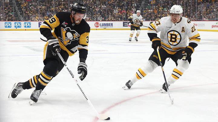 Mar 8, 2026; Pittsburgh, Pennsylvania, USA;  Pittsburgh Penguins right wing Anthony Mantha (39) moves the puck against Boston Bruins defenseman Hampus Lindholm (27) during the first period at PPG Paints Arena. Mandatory Credit: Charles LeClaire-Imagn Images