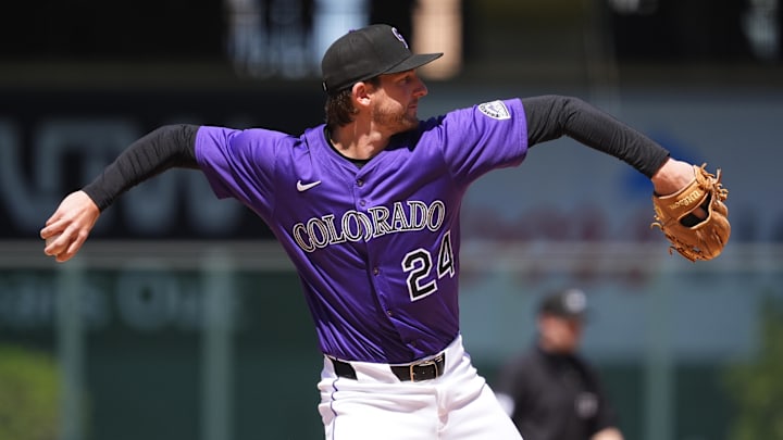 May 8, 2025; Denver, Colorado, USA;  Colorado Rockies third base Ryan McMahon (24) fields the ball seventh inning against the Detroit Tigers at Coors Field. Mandatory Credit: Ron Chenoy-Imagn Images