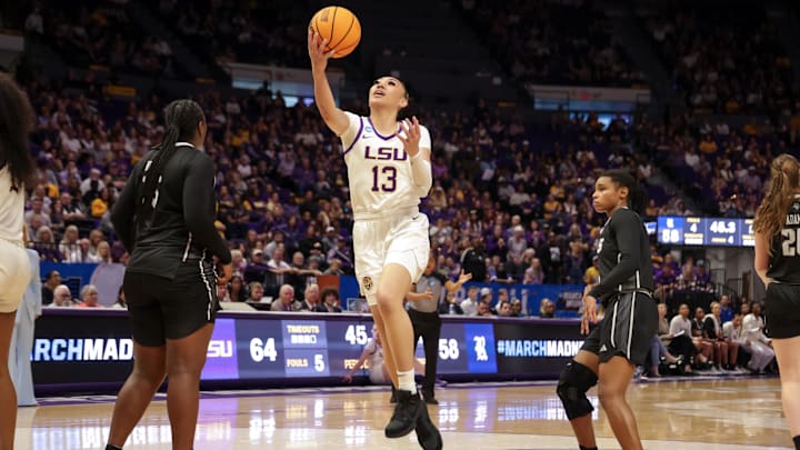 Mar 22, 2024; Baton Rouge, Louisiana, USA; LSU Lady Tigers guard Last-Tear Poa (13) drives to the basket against the Rice Owls during the second half at Pete Maravich Assembly Center. Mandatory Credit: Stephen Lew-Imagn Images