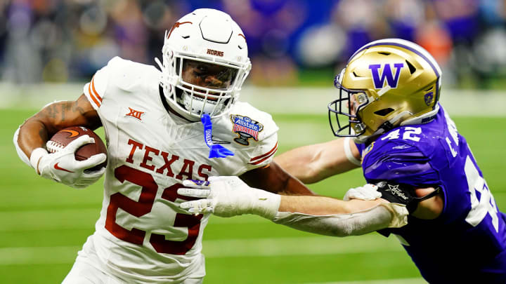 Washington linebacker Carson Bruener (42) reaches for Texas running back Jaydon Blue in the Sugar Bowl.