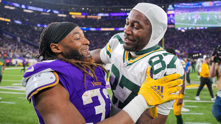 Dec 29, 2024; Minneapolis, Minnesota, USA; Green Bay Packers wide receiver Romeo Doubs (87) and Minnesota Vikings running back Aaron Jones (33) after the game at U.S. Bank Stadium. Mandatory Credit: Brad Rempel-Imagn Images