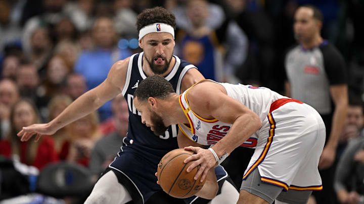 Feb 12, 2025; Dallas, Texas, USA; Golden State Warriors guard Stephen Curry (30) looks to move the ball past Dallas Mavericks guard Klay Thompson (31) during the second half at the American Airlines Center. Mandatory Credit: Jerome Miron-Imagn Images