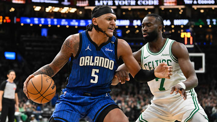 Orlando Magic forward Paolo Banchero (5) is defended by Boston Celtics guard Jaylen Brown (7) during the first half at TD Garden. Orlando Magic forward Paolo Banchero (5) is defended by Boston Celtics guard Jaylen Brown (7) during the first half at TD Garden.