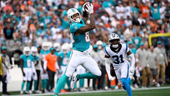 Miami Dolphins tight end Darren Waller (83) catches the ball as Carolina Panthers cornerback Corey Thornton (31) defends in the first quarter at Bank of America Stadium.
