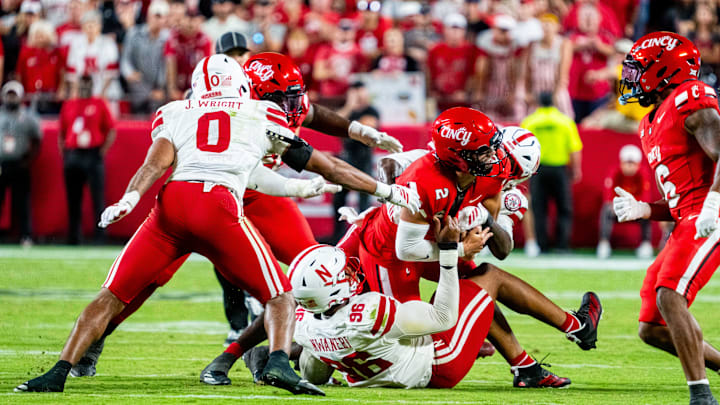 Cincinnati Bearcats quarterback Brendan Sorsby is tackled by Nebraska Cornhuskers defenders during the fourth quarter at GEHA Field at Arrowhead Stadium. Cincinnati Bearcats quarterback Brendan Sorsby is tackled by Nebraska Cornhuskers defenders during the fourth quarter at GEHA Field at Arrowhead Stadium.