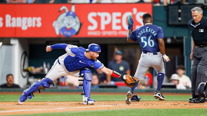 Sep 21, 2024; Arlington, Texas, USA; Texas Rangers catcher Carson Kelly (18) misses a tag of Seattle Mariners outfielder Randy Arozarena (56) during the first inning at Globe Life Field. Mandatory Credit: Andrew Dieb-Imagn Images