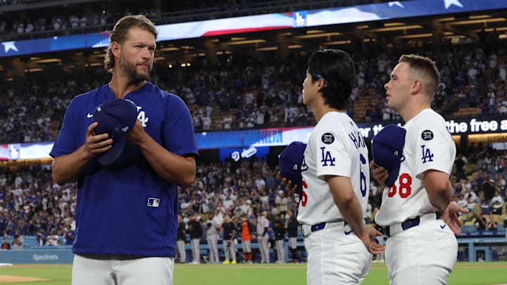 Dodgers pitcher Clayton Kershaw (22) and second base Hyeseong Kim (6) and catcher Dalton Rushing (68) stand for the National anthem prior to the game against the San Francisco Giants on Thursday. Dodgers pitcher Clayton Kershaw (22) and second base Hyeseong Kim (6) and catcher Dalton Rushing (68) stand for the National anthem prior to the game against the San Francisco Giants on Thursday.