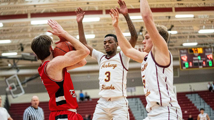 Ankeny's LaMarious Clark (3) and Luke Anderson (5) force a timeout during a game against Cedar Falls on Thursday, Dec. 19, 2024, at Ankeny High School.