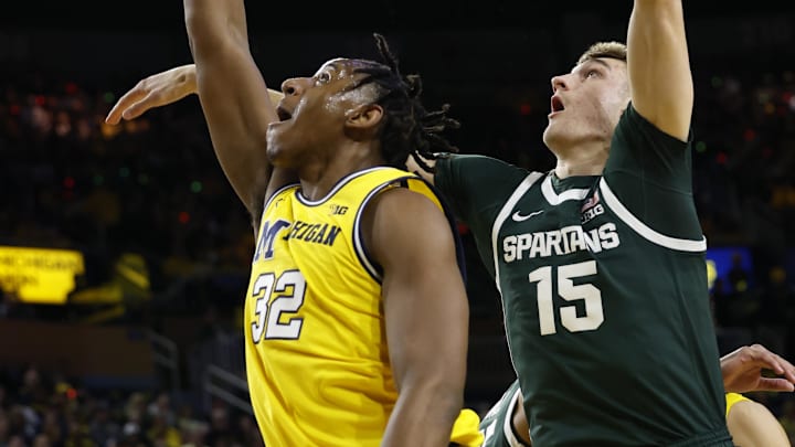 Feb 17, 2024; Ann Arbor, Michigan, USA;  Michigan Wolverines forward Tarris Reed Jr. (32) shoots on Michigan State Spartans center Carson Cooper (15) in the first half at Crisler Center. Mandatory Credit: Rick Osentoski-Imagn Images