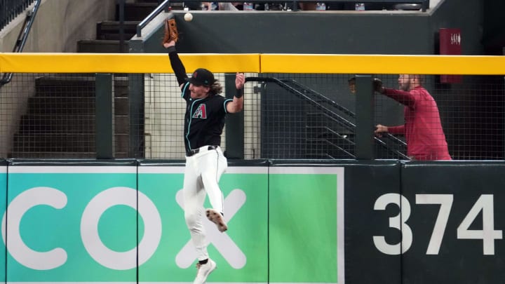 Jun 30, 2024; Phoenix, Arizona, USA; Arizona Diamondbacks outfielder Jake McCarthy (31) is unable to make a catch on a home run ball hit by Oakland Athletics second base Zack Gelof (20) during the fifth inning at Chase Field. Mandatory Credit: Joe Camporeale-USA TODAY Sports