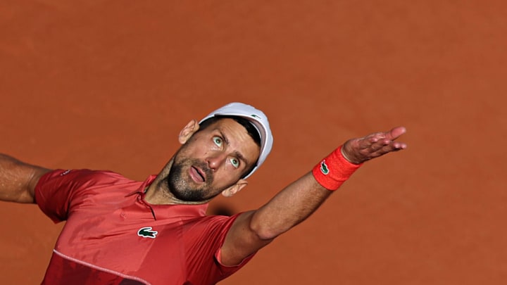 Novak Djokovic serves the ball during a match at the French Open.