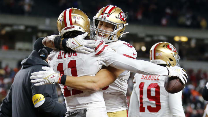 49ers wide receiver Brandon Aiyuk celebrates with teammates after scoring the game-winning touchdown against the Bengals in December 2021.