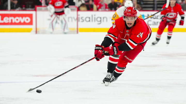 Nov 7, 2024; Raleigh, North Carolina, USA;  Carolina Hurricanes center Seth Jarvis (24) skates with the puck against the Pittsburgh Penguins during the first period at Lenovo Center. Mandatory Credit: James Guillory-Imagn Images