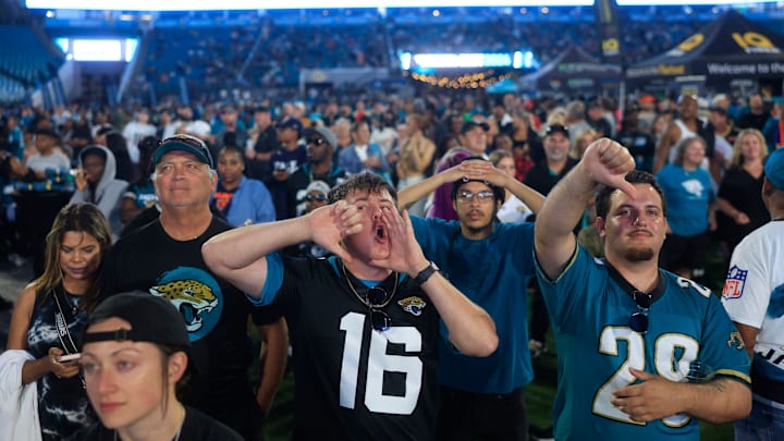 Coleman Marley, center, boos expressing his opinion of NFL Commissioner Roger Goodell kicks off the