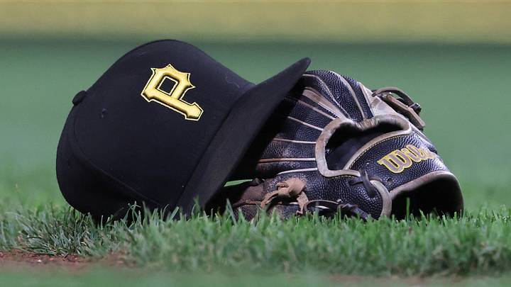 Sep 16, 2025; Pittsburgh, Pennsylvania, USA; A hat and glove belonging to Pittsburgh Pirates third baseman Jared Triolo (not pictured) on the field against the Chicago Cubs during the sixth inning at PNC Park. Mandatory Credit: Charles LeClaire-Imagn Images