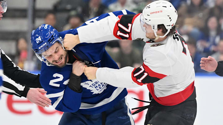 Mar 15, 2025; Toronto, Ontario, CAN;  Ottawa Senators forward Ridly Greig (71) lands a punch on Toronto Maple Leafs forward Scott Laughton (24) as they fight in the second period at Scotiabank Arena. Mandatory Credit: Dan Hamilton-Imagn Images