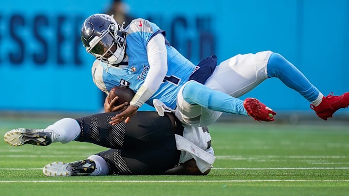 Tennessee Titans quarterback Cam Ward (1) is sacked by Jacksonville Jaguars defensive end Josh Hines-Allen (41) during the fourth quarter at Nissan Stadium in Nashville, Tenn., Sunday, Nov. 30, 2025.