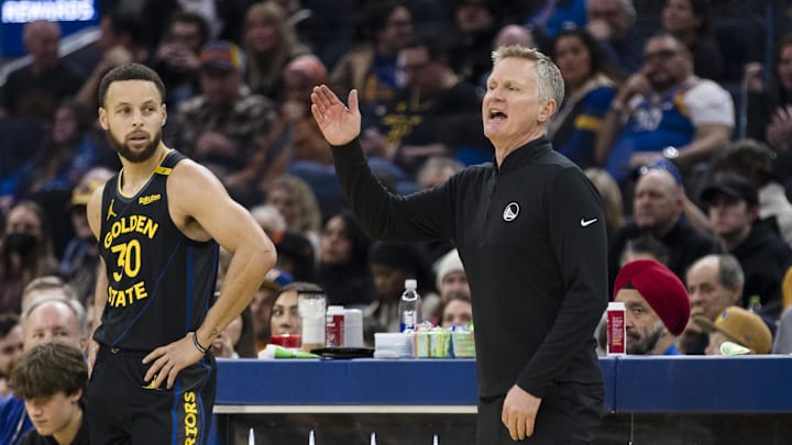 Dec 30, 2024; San Francisco, California, USA; Golden State Warriors guard Stephen Curry (30) watches as head coach Steve Kerr reacts during the first quarter of the game against the Cleveland Cavaliers against the Cleveland Cavaliers at Chase Center. Mandatory Credit: John Hefti-Imagn Images Dec 30, 2024; San Francisco, California, USA; Golden State Warriors guard Stephen Curry (30) watches as head coach Steve Kerr reacts during the first quarter of the game against the Cleveland Cavaliers against the Cleveland Cavaliers at Chase Center. Mandatory Credit: John Hefti-Imagn Images