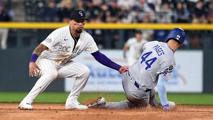 Jun 25, 2025; Denver, Colorado, USA; Los Angeles Dodgers outfielder Andy Pages (44) is tagged out by Colorado Rockies shortstop Orlando Arcia (11) trying to steal second base during the eighth inning at Coors Field.