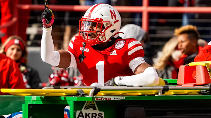 Nebraska defensive back Marques Buford Jr. signals to fans as he is driven off the field after being injured during the Huskers' 2022 game against Wisconsin.