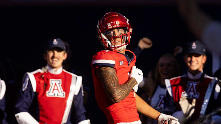 Nov 30, 2024; Tucson, Arizona, USA; Arizona Wildcats wide receiver Tetairoa McMillan (4) celebrates a touchdown against the Arizona State Sun Devils in the second half during the Territorial Cup at Arizona Stadium. Mandatory Credit: Mark J. Rebilas-Imagn Images