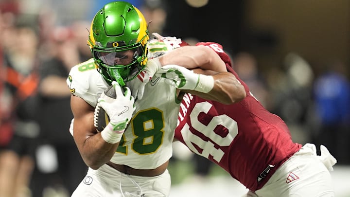 Jan 9, 2026; Atlanta, GA, USA; Oregon Ducks tight end Kenyon Sadiq (18) runs against Indiana Hoosiers linebacker Isaiah Jones (46)during the first quarter of the 2025 Peach Bowl and semifinal game of the College Football Playoff at Mercedes-Benz Stadium. Mandatory Credit: Dale Zanine-Imagn Imagesf