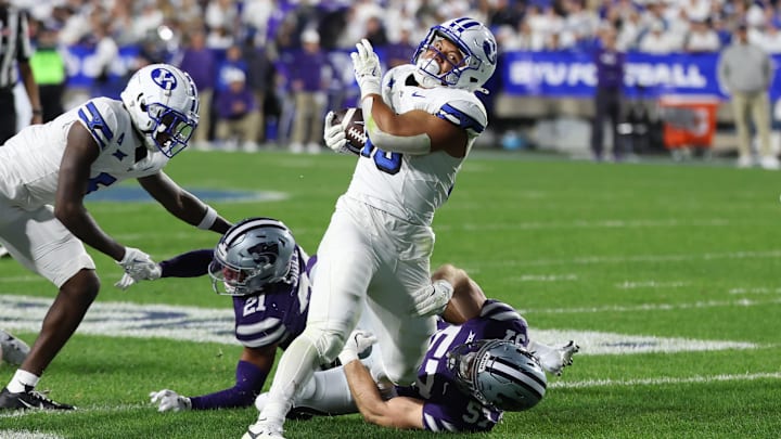 BYU running back Sione Moa fights through defenders to battle to the endzone.