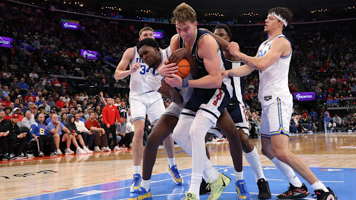 Nov 14, 2025; Inglewood, California, USA;  Arizona Wildcats center Motiejus Krivas (13) and UCLA Bruins center Xavier Booker (1) fight for a rebound during the first half of the Hall of Fame Series game at Intuit Dome. Mandatory Credit: Kiyoshi Mio-Imagn Images
