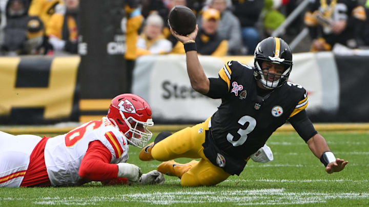 Dec 25, 2024; Pittsburgh, Pennsylvania, USA; A Kansas City Chiefs defensive end George Karlaftis (56) tackles Pittsburgh Steelers quarterback Russell Wilson (3) during the first quarter at Acrisure Stadium. Mandatory Credit: Barry Reeger-Imagn Images