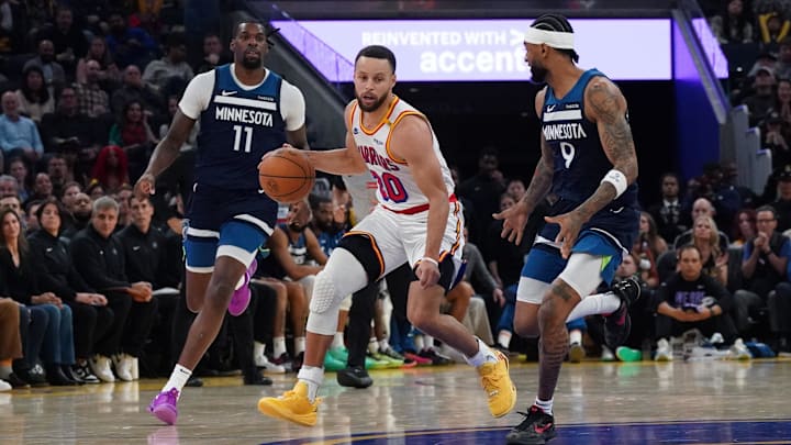 Golden State Warriors guard Stephen Curry dribbles upcourt against Minnesota Timberwolves center-forward Naz Reid (11) and guard Nickeil Alexander-Walker in the third quarter at Chase Center in San Francisco on Dec. 8, 2024.