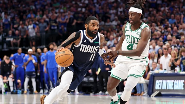 Jun 12, 2024; Dallas, Texas, USA; Dallas Mavericks guard Kyrie Irving (11) dribbles the ball against Boston Celtics guard Jrue Holiday (4) during the fourth quarter during game three of the 2024 NBA Finals at American Airlines Center. Mandatory Credit: Kevin Jairaj-USA TODAY Sports