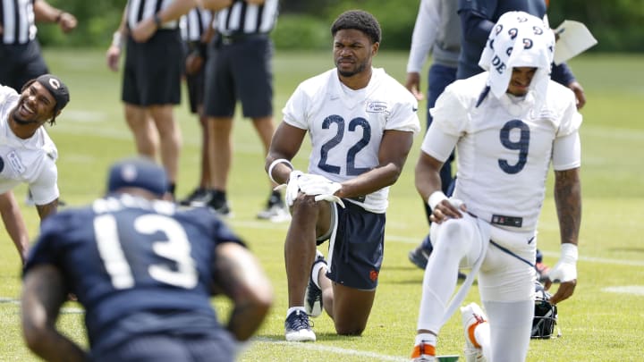 Elijah Hicks (22), Jaquan Brisker, Keenan Allen and the Bears go through stretching during minicamp. Practices start July 20.