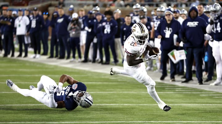 Dec 26, 2023; Dallas, TX, USA; Texas State Bobcats running back Ismail Mahdi (21) runs with the ball against Rice Owls defensive back AJ Stephens (25) in the second quarter at Gerald J Ford Stadium. Mandatory Credit: Tim Heitman-Imagn Images