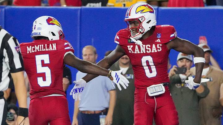 Sep 11, 2026; Lawrence, Kansas, USA; Kansas Jayhawks wide receiver Nahzae Cox (0) celebrates with wide receiver Nik McMillan (5) against the Missouri Tigers during the second half of the game at David Booth Kansas Memorial Stadium. Mandatory Credit: Denny Medley-Imagn Images