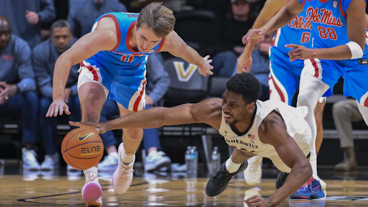 Jan 31, 2026; Nashville, TN, USA;  Vanderbilt Commodores forward Ak Okereke (10) dives for the loose ball from Mississippi Rebels guard Travis Perry (11) during the first half at Memorial Gymnasium. Mandatory Credit: Steve Roberts-Imagn Images