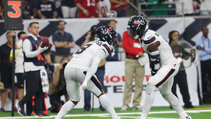 Sep 15, 2025; Houston, Texas, USA; Houston Texans safety C.J. Gardner-Johnson (8) and Houston Texans linebacker Azeez Al-Shaair (0) celebrate after making a tackle during the second quarter against the Tampa Bay Buccaneers at NRG Stadium. Mandatory Credit: Thomas Shea-Imagn Images