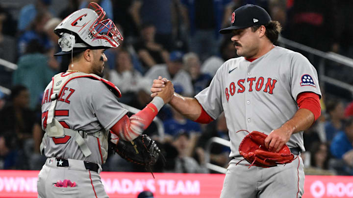 Boston Red Sox catcher Carlos Narvaez (75) and relief pitcher Payton Tolle (70) celebrate a win over the Toronto Blue Jays at Rogers Centre.