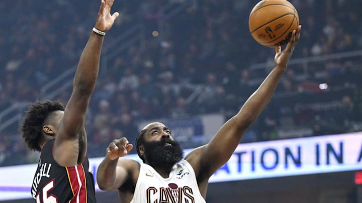 Mar 25, 2026; Cleveland, Ohio, USA; Cleveland Cavaliers guard James Harden (1) drives to the basket beside Miami Heat guard Davion Mitchell (45) in the third quarter at Rocket Arena. Mandatory Credit: David Richard-Imagn Images