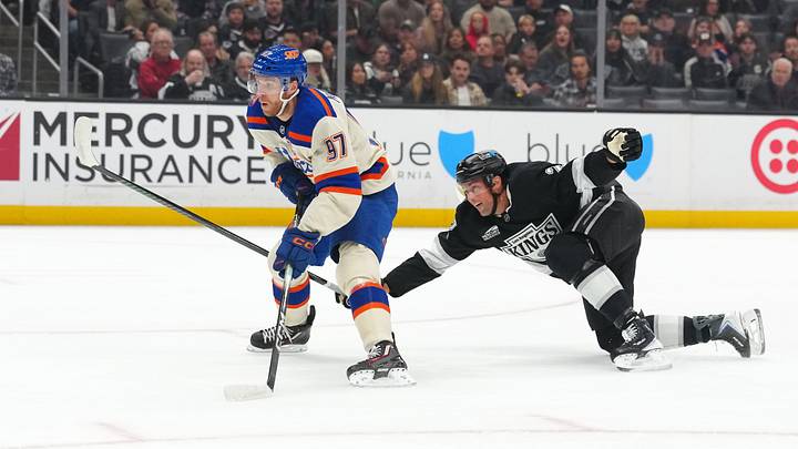 Oct 13, 2026; Los Angeles, California, USA; Edmonton Oilers center Connor McDavid (97) skates with the puck against LA Kings defenseman Brian Dumoulin (2) in the first period at Crypto.com Arena. Mandatory Credit: Kirby Lee-Imagn Images