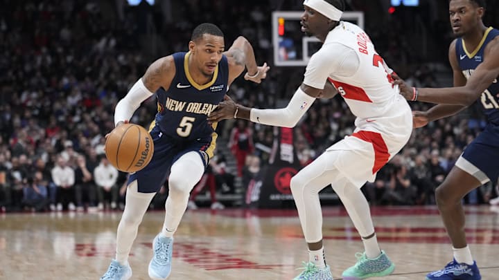 Pelicans guard Dejounte Murray drives to the basket past Toronto's forward Chris Boucher. Pelicans guard Dejounte Murray drives to the basket past Toronto's forward Chris Boucher.