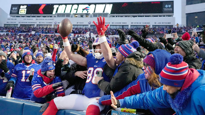 Bills tight end Dawson Knox leaps into the stands to celebrate with fans after scoring the opening touchdown of the game in first quarter against the Jets during the first half of their last regular season game at Highmark Stadium.