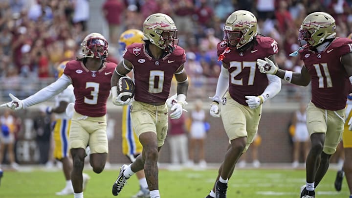 Oct 11, 2025; Tallahassee, Florida, USA; Florida State Seminoles safety Earl Little Jr. (0), defensive back Ashlynd Barker (27), defensive back Edwin Joseph (3), and defensive back Ja'Bril Rawls (11) celebrate after an interception during the first half of the game against the Pittsburgh Panthers at Doak S. Campbell Stadium. Mandatory Credit: Melina Myers-Imagn Images